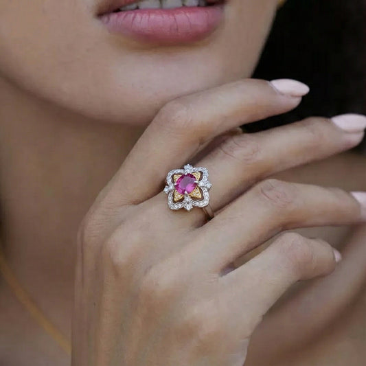 Awakened Time La Rosa di Firenze dual-tone gold vermeil and garnet ring styled on a hand, highlighting its Renaissance-inspired floral silhouette.