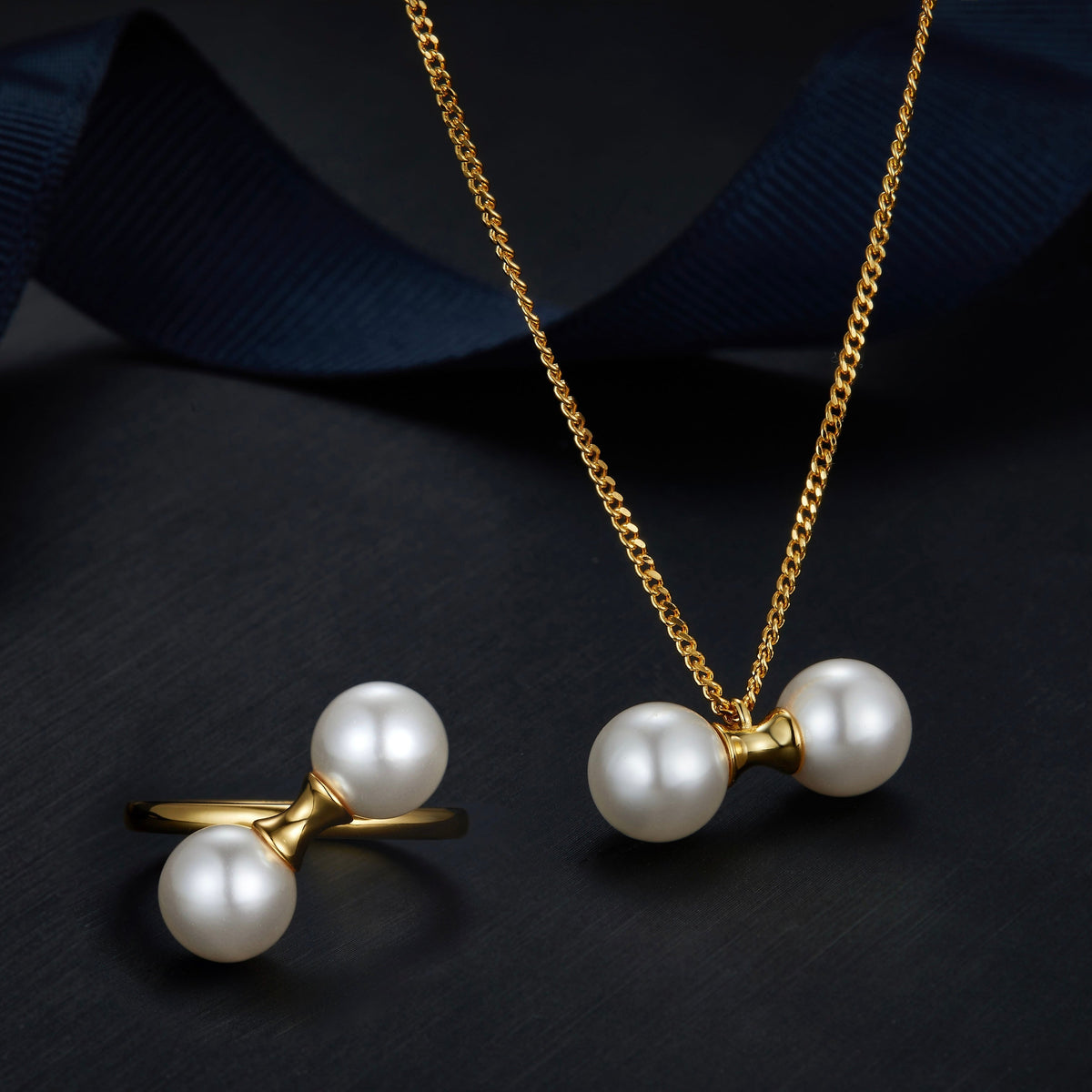 Matching 18ct gold vermeil pearl jewelry set featuring The Petite Symétrie ring and necklace by Awakened Time.