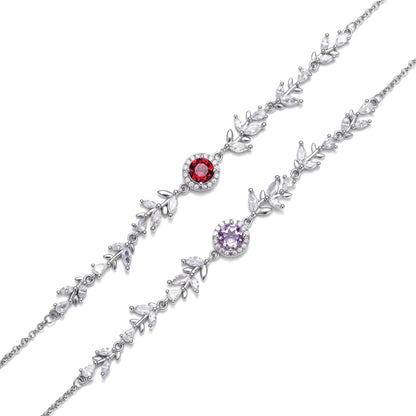 Two Awakened Time Wheatline sterling silver bracelets displayed side by side, featuring leaf-like cubic zirconia links and central gemstone options in deep red garnet and light purple amethyst.