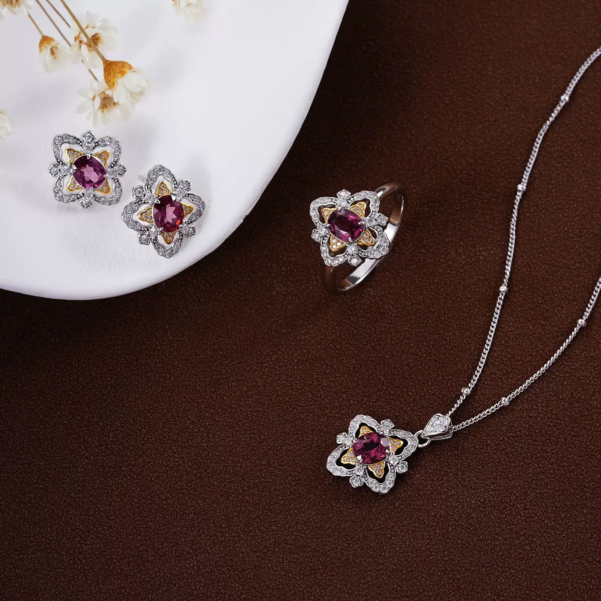 Awakened Time La Rosa di Firenze Renaissance-inspired floral garnet collection featuring the matching ring, earrings, and necklace set displayed together.